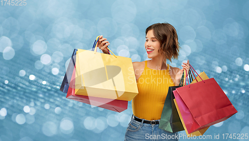 Image of happy smiling young woman with shopping bags