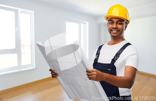 Image of happy indian builder in helmet with blueprint