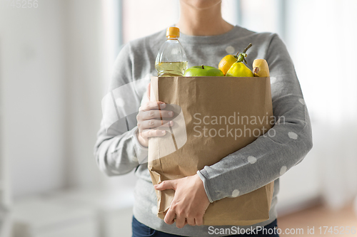 Image of close up of woman with paper bag full of food