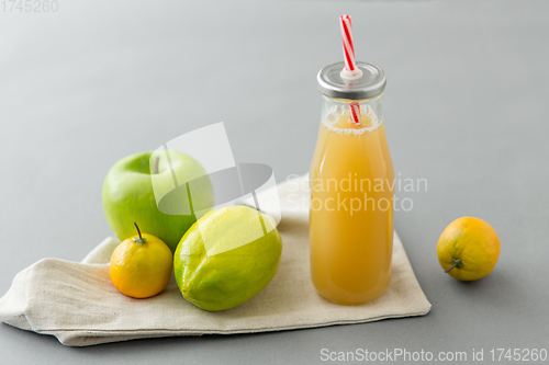 Image of reusable glass bottle of fruit juice with straw