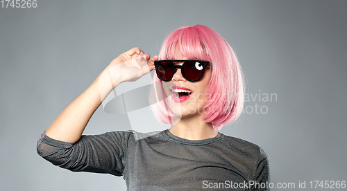 Image of happy woman in pink wig and black sunglasses