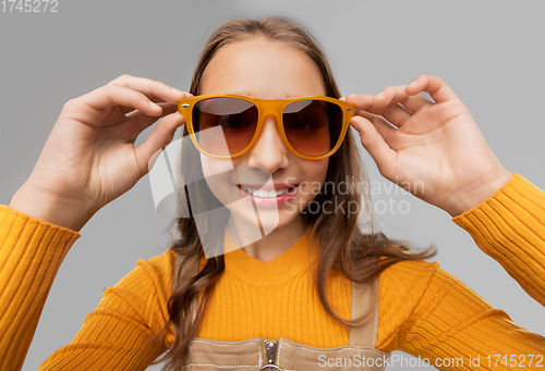 Image of smiling young teenage girl in sunglasses