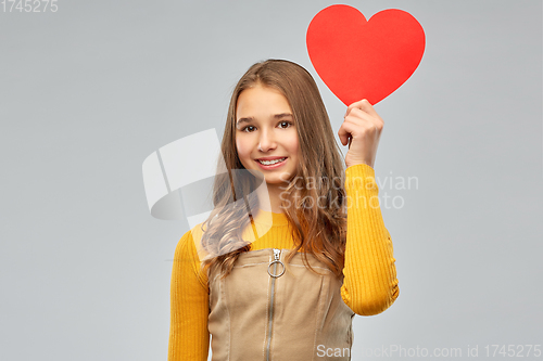 Image of smiling teenage girl with red heart