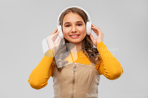 Image of teenage girl in headphones listening to music