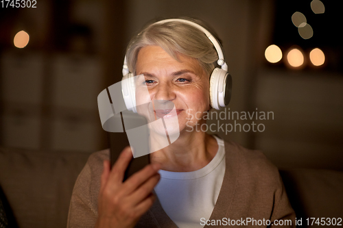 Image of senior woman in headphones listening to music