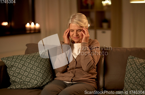 Image of unhappy senior woman suffering from headache
