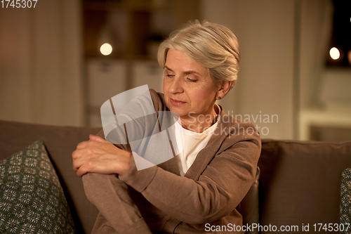 Image of senior woman suffering from pain in hand at home