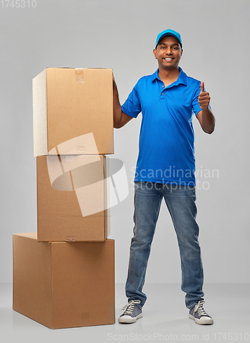 Image of happy indian delivery man with parcel boxes