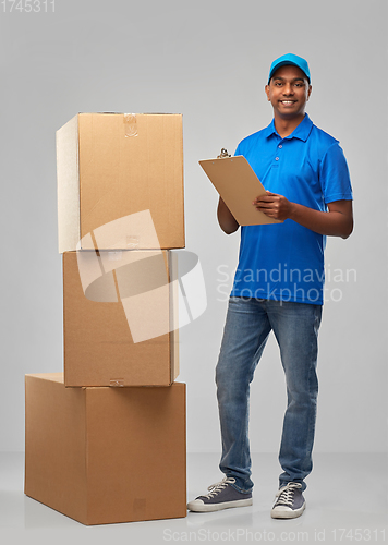 Image of indian delivery man with boxes and clipboard