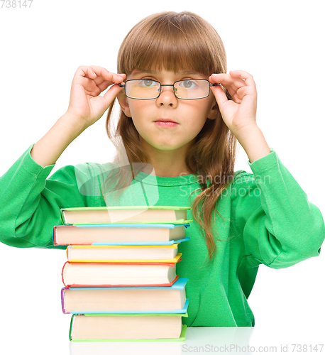 Image of Little girl is reading a book