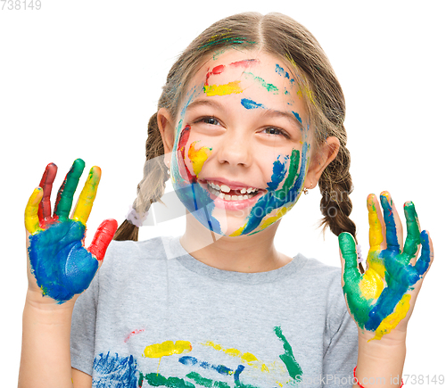 Image of Portrait of a cute girl playing with paints