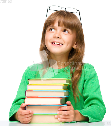 Image of Little girl is reading a book