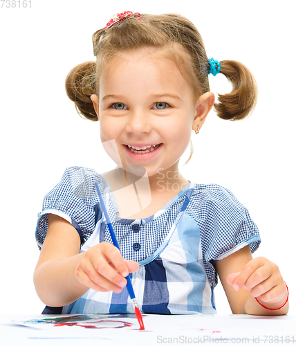 Image of Little girl is painting with gouache