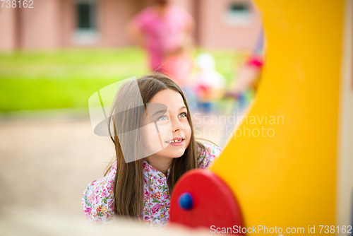 Image of Cute little girl is playing in playground