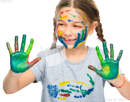 Image of Portrait of a cute girl playing with paints