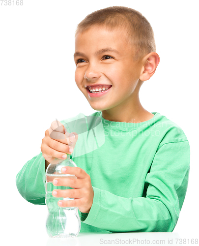 Image of Boy with plastic bottle of water