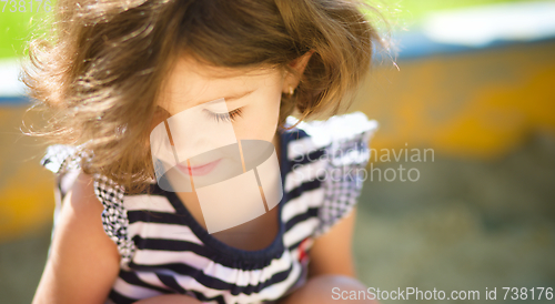 Image of Cute little girl is playing in playground