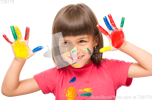 Image of Portrait of a cute girl playing with paints