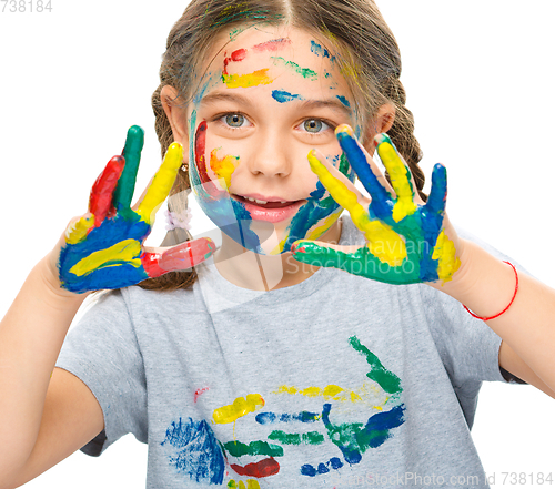 Image of Portrait of a cute girl playing with paints