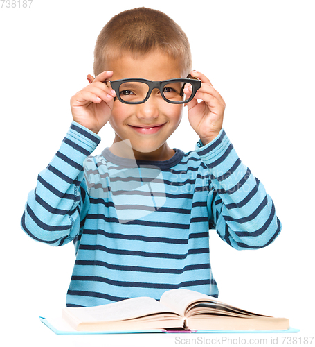 Image of Little boy is reading a book