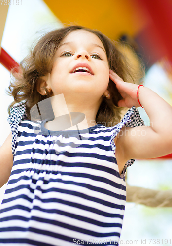 Image of Cute little girl is playing in playground