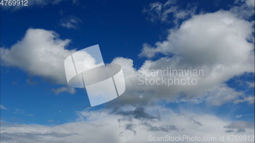 Image of Time lapse Fluffy clouds float across the blue sky. UltraHD stock footage