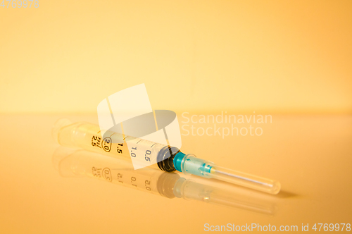 Image of Syringe on orange background