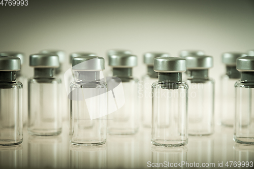 Image of Vaccine glass bottles on grey background