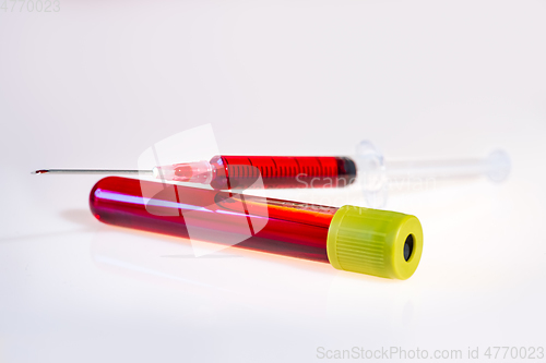 Image of Syringe and tube with blood on white background