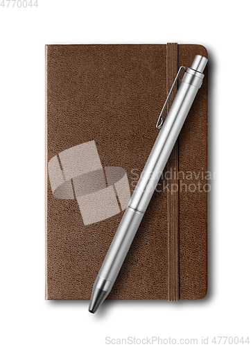 Image of Dark Leather closed notebook and pen isolated on white