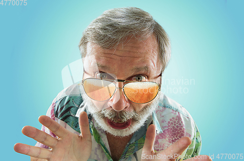 Image of Oktoberfest senior man with sunglasses full of light beer