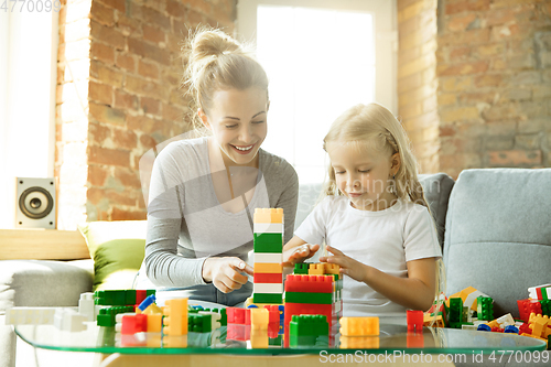 Image of Teacher and little girl, or mom and daughter. Homeschooling concept