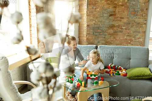 Image of Teacher and little girl, or mom and daughter. Homeschooling concept