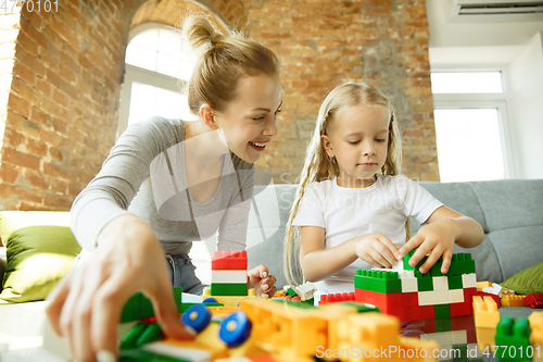 Image of Teacher and little girl, or mom and daughter. Homeschooling concept