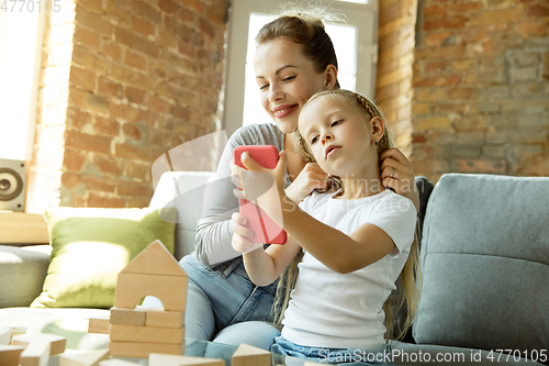 Image of Teacher and little girl, or mom and daughter. Homeschooling concept