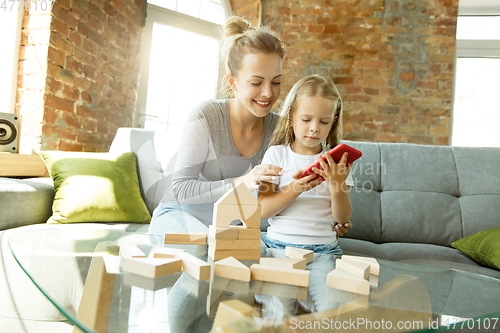 Image of Teacher and little girl, or mom and daughter. Homeschooling concept