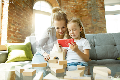 Image of Teacher and little girl, or mom and daughter. Homeschooling concept