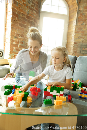 Image of Teacher and little girl, or mom and daughter. Homeschooling concept