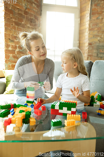 Image of Teacher and little girl, or mom and daughter. Homeschooling concept