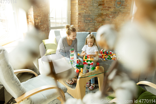 Image of Teacher and little girl, or mom and daughter. Homeschooling concept