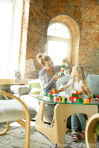 Image of Teacher and little girl, or mom and daughter. Homeschooling concept