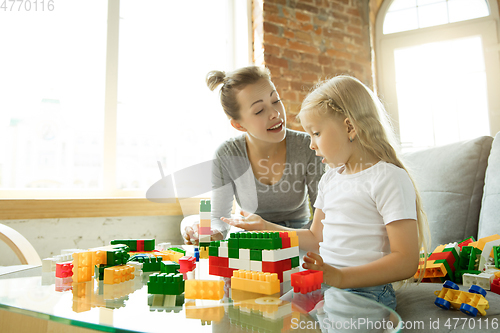 Image of Teacher and little girl, or mom and daughter. Homeschooling concept