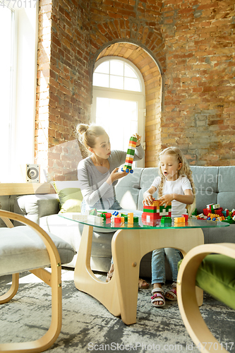 Image of Teacher and little girl, or mom and daughter. Homeschooling concept