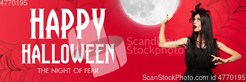 Image of Young woman in hat as a witch on scary red background