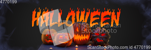 Image of Scary pumpkins on black background, the night of fear