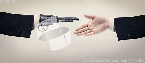 Image of Two male hands shaking isolated on blue studio background