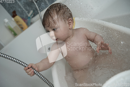 Image of cute little baby girl taking a bath