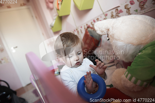 Image of cute little one year old baby and making first steps