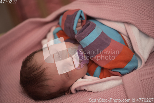 Image of One month newborn baby sleeping in bed