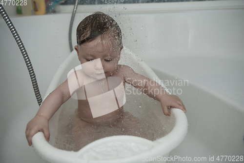 Image of cute little baby girl taking a bath